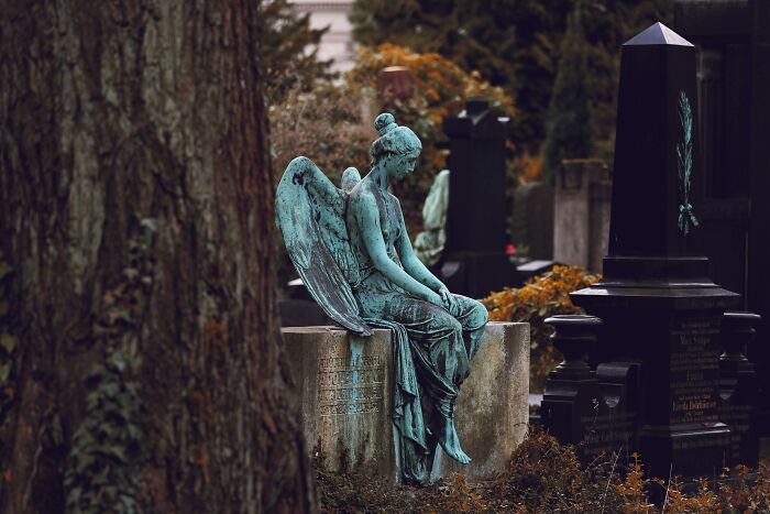 An aged angel statue in a cemetery, a haunting image that could be part of strange experiences people shiver at.