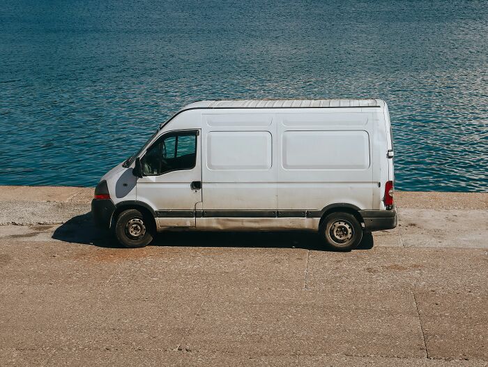 A white van parked beside a body of water, a common sight that can precede strange experiences people shiver at.