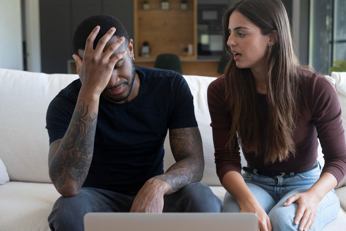 A frustrated husband puts his hand on his head as his wife expresses her theory about a criminal trial.