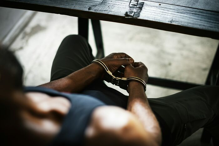A person in handcuffs, symbolizing a bad wedding moment.