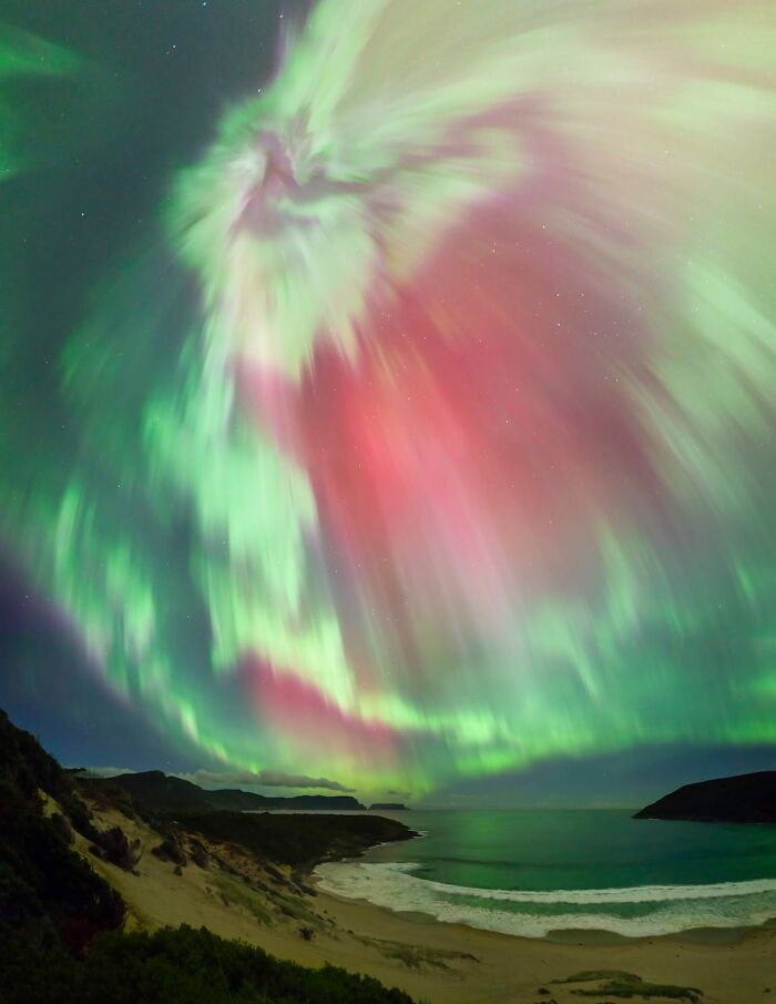 Vibrant aurora borealis over a coastal landscape, a breathtaking image from the David Malin Astrophotography Awards 2026.