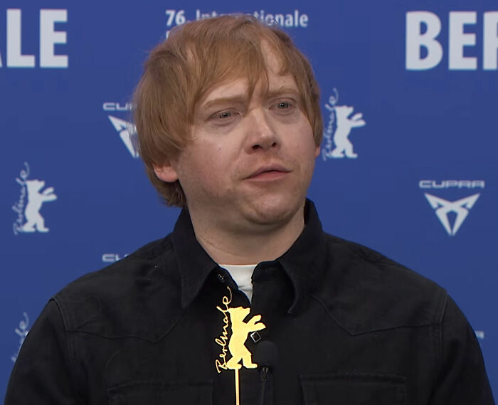 Rupert Grint looking at the camera with a neutral expression, for his iconic Harry Potter role. Rupert Grint looking at the camera with a neutral expression, for his iconic Harry Potter role.