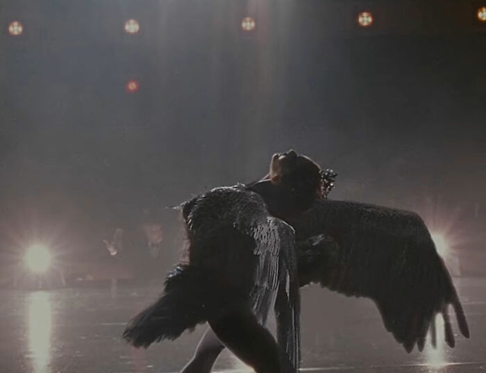 Natalie Portman in character as a black swan, dancing on stage; a look at her diva reputation and career.