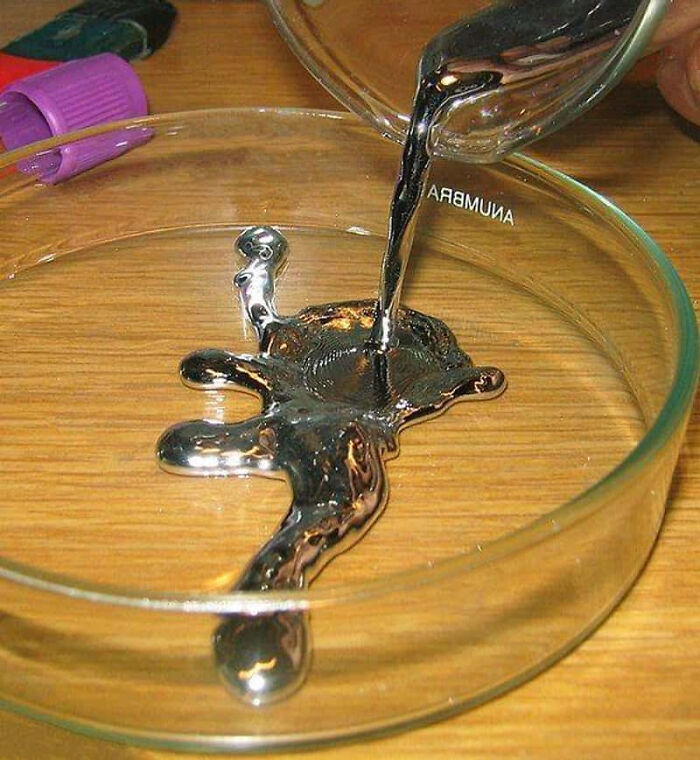 Liquid mercury being poured into a petri dish, representing terrifying past medical tools and methods doctors used.