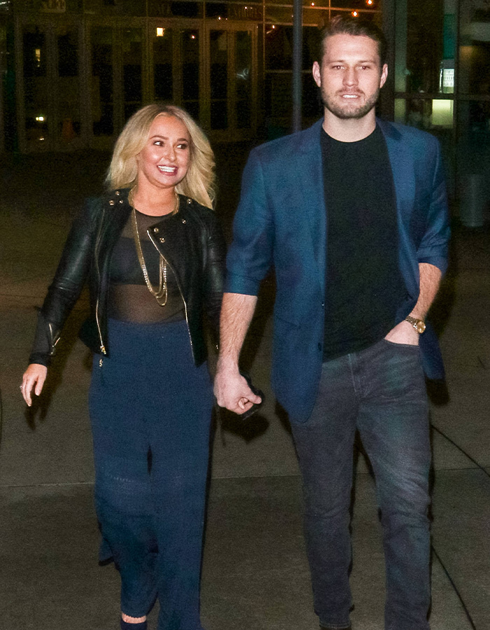 Hayden Panettiere walking hand-in-hand with a man, possibly her partner, revealing personal aspects from her memoir.