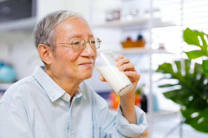 An older man happily drinking milk, a patient image related to health and things patients have said to doctors.