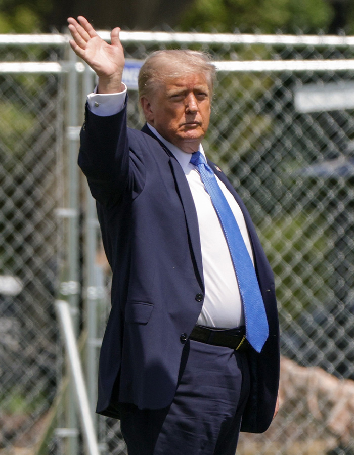 Donald Trump in a blue suit and tie, raising his hand, facing a health marker in his prognosis. Donald Trump in a blue suit and tie, raising his hand, facing a health marker in his prognosis.