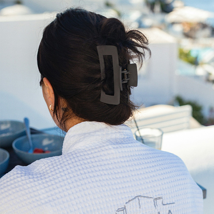 A woman wearing a hair accessory that can cause life-threatening injuries, enjoying her time on the balcony.