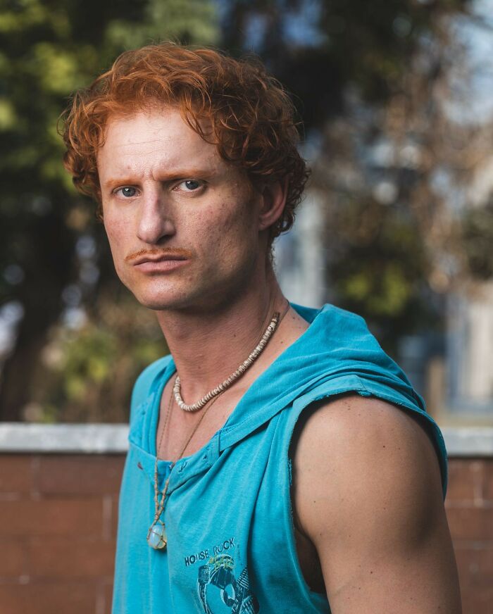 A man with red hair and a mustache, a reminder for tourists to be respectful when they visit other countries.