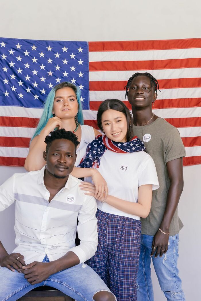 Diverse Americans in front of a US flag, reminding visitors to be respectful when they visit other countries.