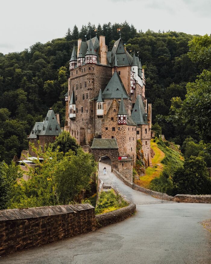 A majestic castle surrounded by lush forest, a beautiful destination for tourists to be respectful when they visit other countries.