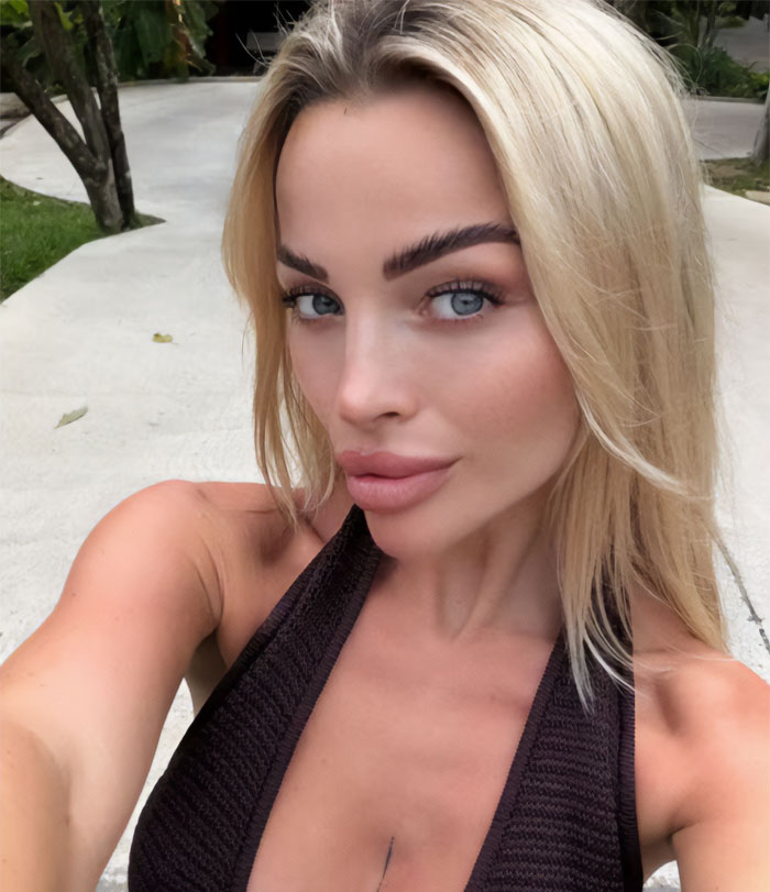 Young woman posing for a selfie in Bali, sharing her nightmare experience for travelers to be careful.