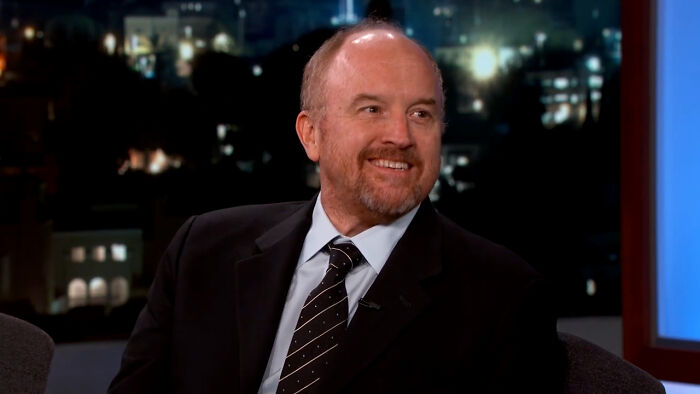 Comedian Louis C.K. smiles during an interview about what dating a celebrity is like.