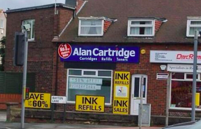 A store called 'Alan Cartridge' selling ink refills, a subtle instance of British humor.