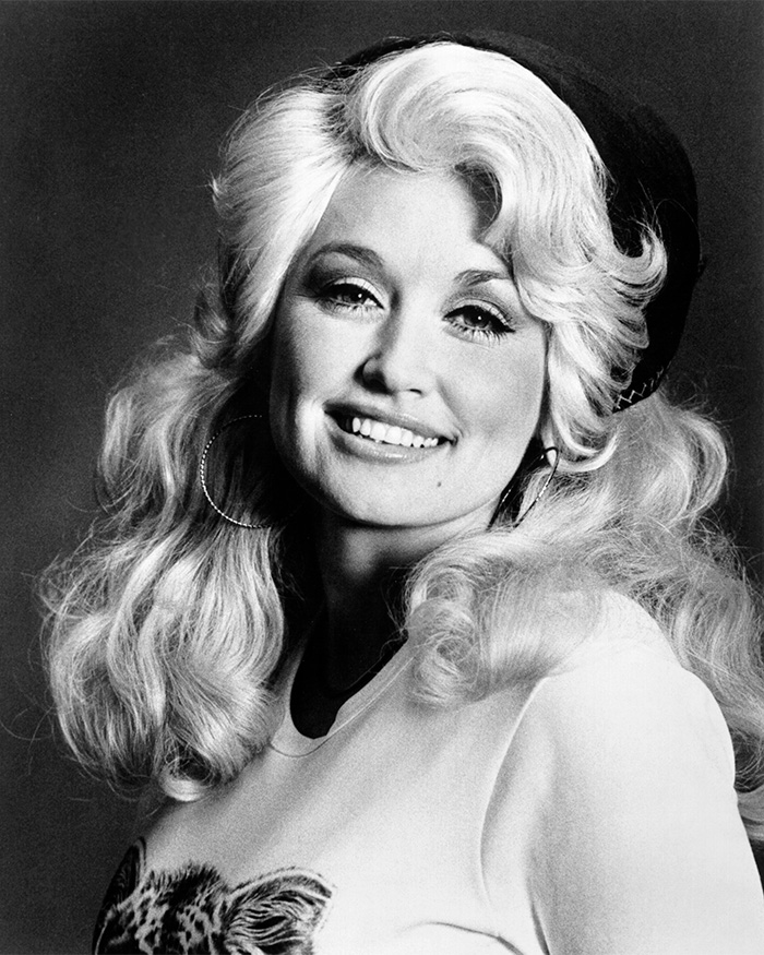 Black and white photo of a young Dolly Parton smiling, with long blonde hair, sending a sweet letter to Eminem.