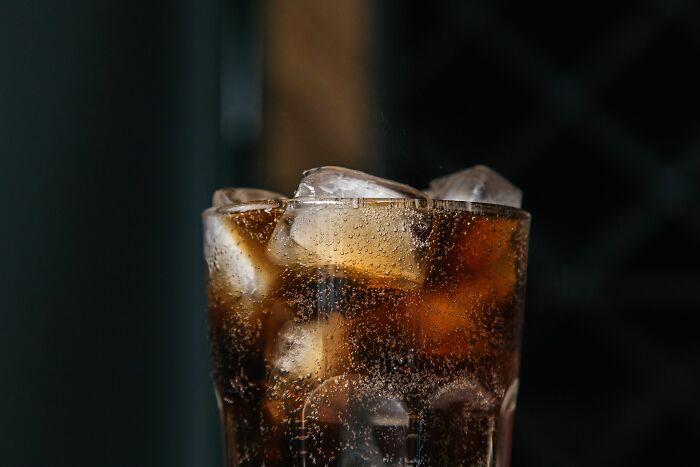 A close-up of a glass of cola with ice and bubbles, symbolizing various customer interactions.