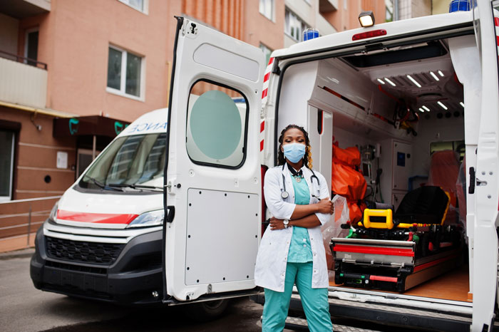 Paramedic standing in front of an open ambulance door, preparing for an ambulance ride. Man throws a fit.