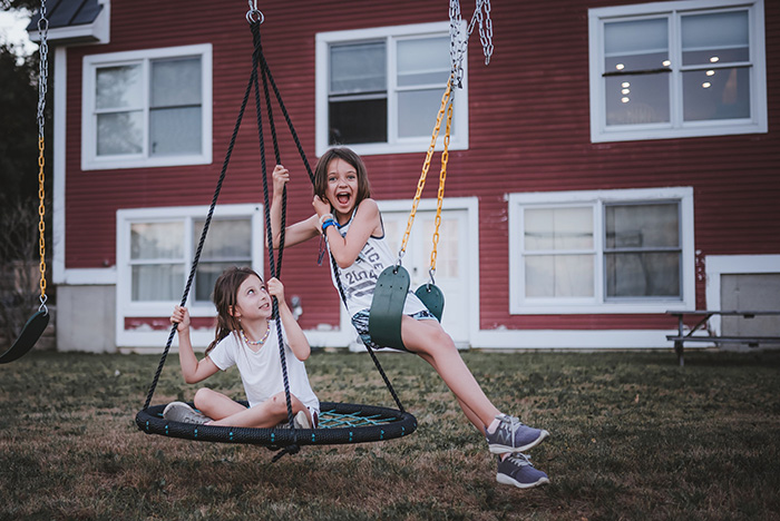 Kids playing on swings, ignoring property lines, leading to a situation with trespassing neighbors. Kids playing on swings, ignoring property lines, leading to a situation with trespassing neighbors.