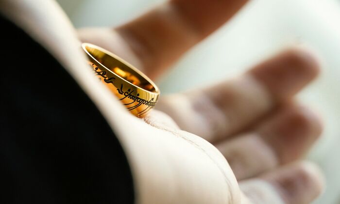 A golden ring in a hand, symbolizing the commitment and truths about being married.
