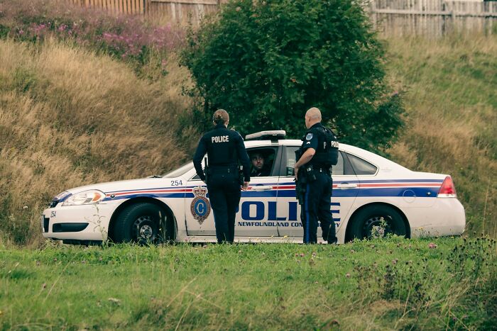 Police officers with a patrol car, representing a bad wedding moment.