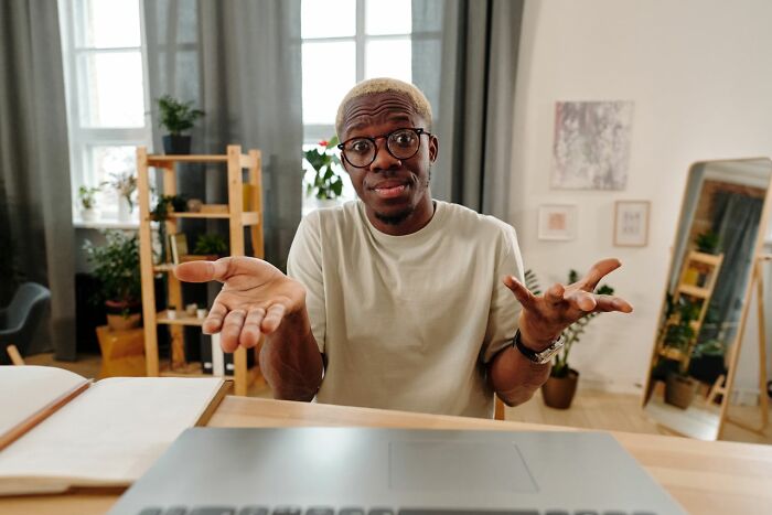 A man shrugging with a confused expression, highlighting questions Americans asked Europeans.