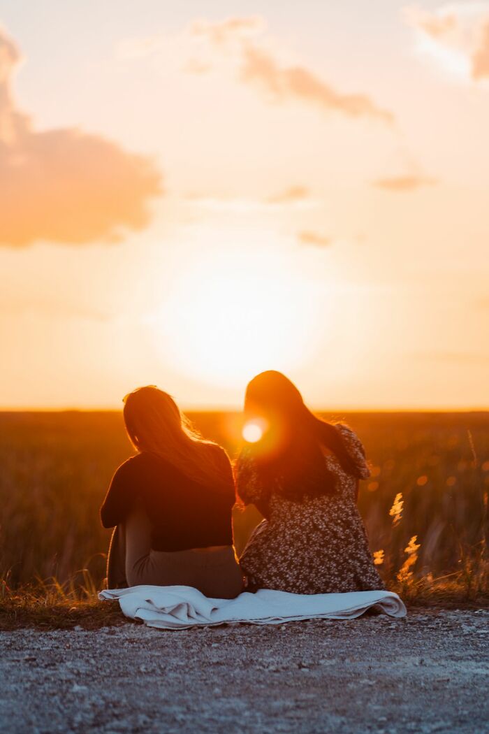 Two women watching the sunset, pondering serious questions Americans asked Europeans.