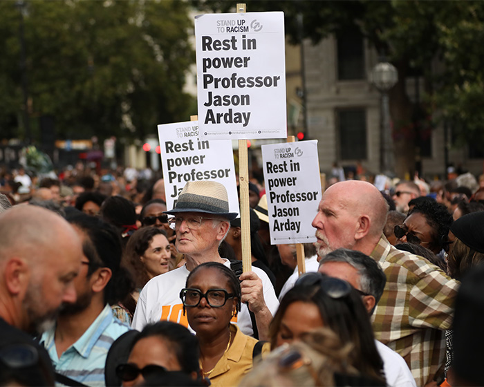People holding signs that read Rest in Power Professor Jason Arday, mourning the ex-Cambridge Professor. People holding signs that read Rest in Power Professor Jason Arday, mourning the ex-Cambridge Professor.
