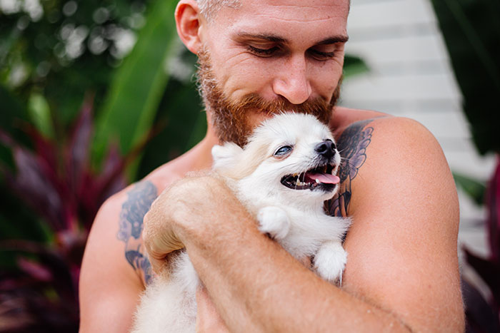 A happy man with a beard and tattoos holding a small white dog, an image that does not align with the title of jobless ex-husband and petty revenge. A happy man with a beard and tattoos holding a small white dog, an image that does not align with the title of jobless ex-husband and petty revenge.