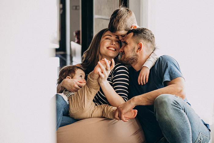 A happy family, with a woman, man, and two young children, illustrating life after revenge on a jobless ex-husband. A happy family, with a woman, man, and two young children, illustrating life after revenge on a jobless ex-husband.