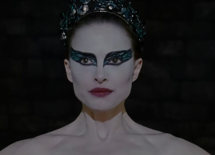 Natalie Portman as a Black Swan, with striking makeup, embodying her diva reputation.