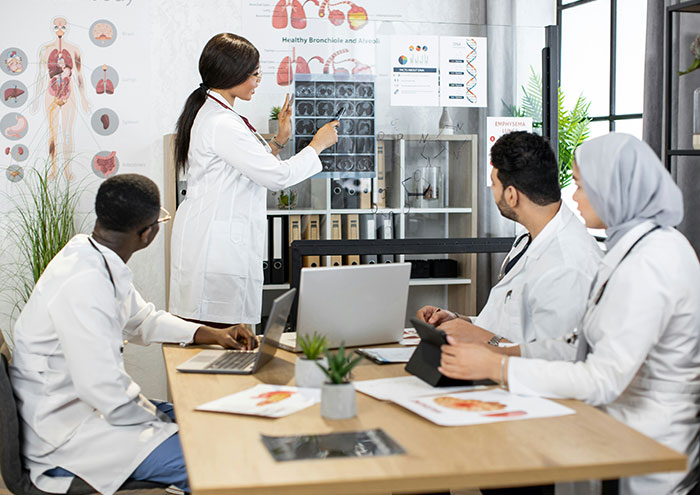 A group of diverse medical professionals examining scans, discussing bodies donated for science at Harvard. A group of diverse medical professionals examining scans, discussing bodies donated for science at Harvard.