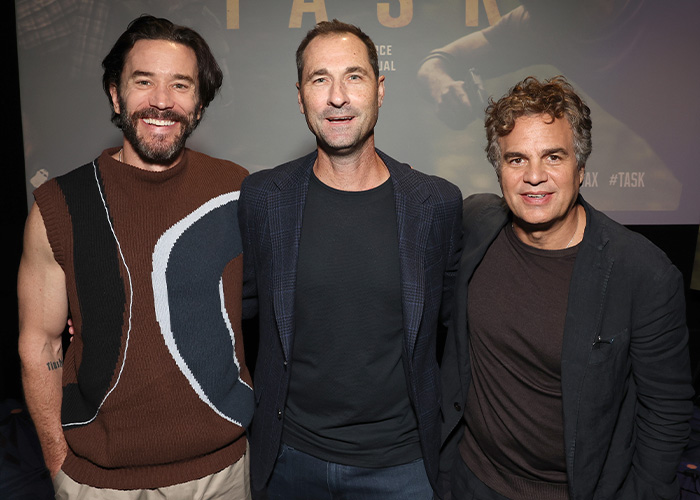 Three famous men, including Mark Ruffalo, smile at an event, known for being shorter than expected.