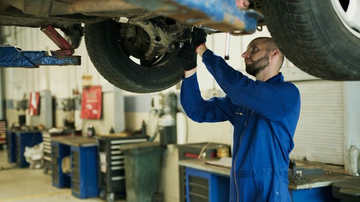 A mechanic working under a car, symbolizing how people in their lives can't respect anymore.