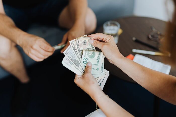 Hands exchanging money, representing reasons people in their lives can't respect anymore.