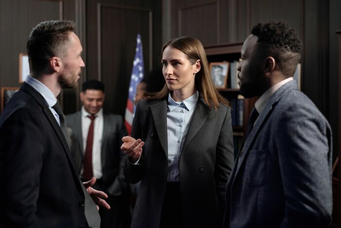Three professionals engaged in a serious discussion, highlighting issues with people in their lives they can’t respect.