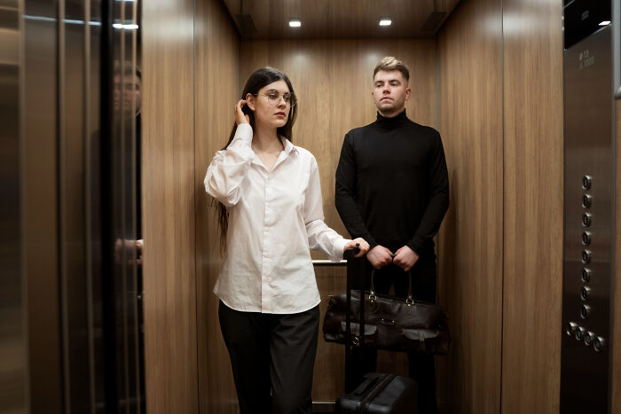 Two people in an elevator, showing everyday encounters with people in their lives.