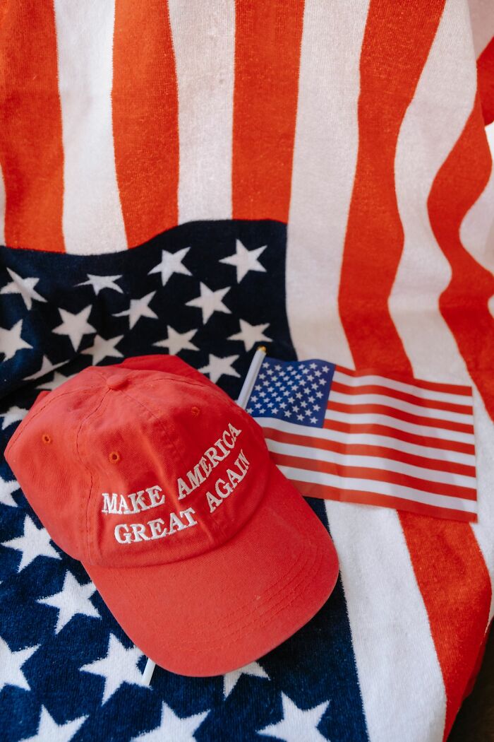 A red MAGA hat and an American flag, symbolizing why some people can't respect others anymore.