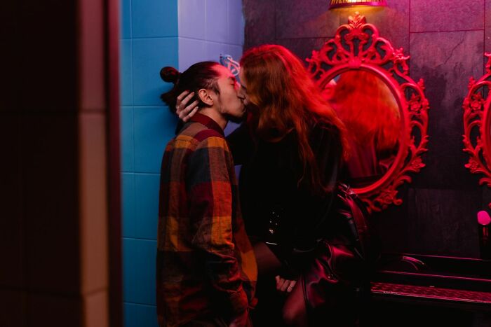 Couple kissing passionately in a club, illustrating how some people in their lives might lose respect.