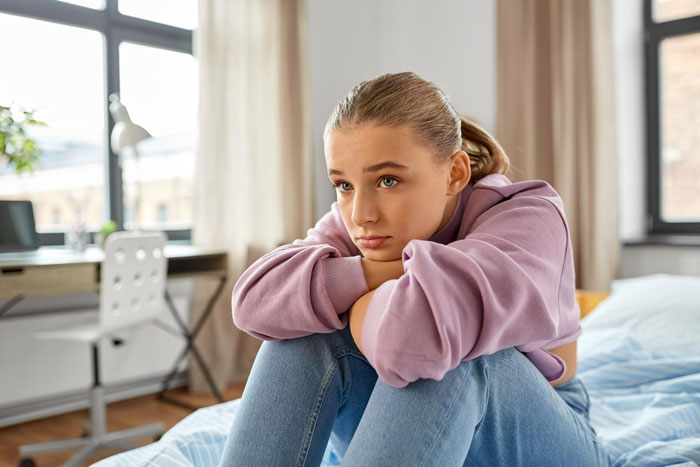 A young woman with a sad expression, reflecting on her father-daughter bond and a paranoid mom. A young woman with a sad expression, reflecting on her father-daughter bond and a paranoid mom.