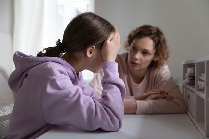 A teenage daughter sits upset with her mother, who is a paranoid mom, ruining their father-daughter bond. A teenage daughter sits upset with her mother, who is a paranoid mom, ruining their father-daughter bond.