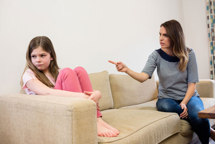 A mom scolding her daughter, straining their father-daughter bond. A mom scolding her daughter, straining their father-daughter bond.