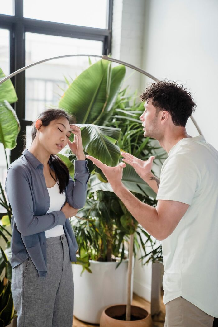 A man arguing with a woman holding her head. Women shut down creepy men with savage ways.