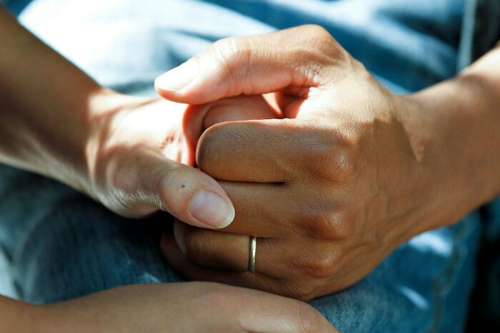 Clasped hands, representing support and the emotional impact of cancer treatment and severe side effects. Clasped hands, representing support and the emotional impact of cancer treatment and severe side effects.