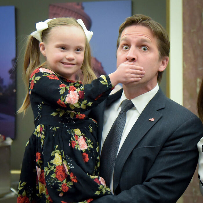 A little girl covering a man's mouth, illustrating the difficulty of discussing cancer med side effects. A little girl covering a man's mouth, illustrating the difficulty of discussing cancer med side effects.