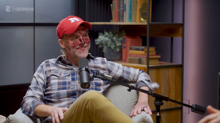 Man with facial wounds and a red hat, discussing cancer med side effects and disease treatment on a podcast. Man with facial wounds and a red hat, discussing cancer med side effects and disease treatment on a podcast.
