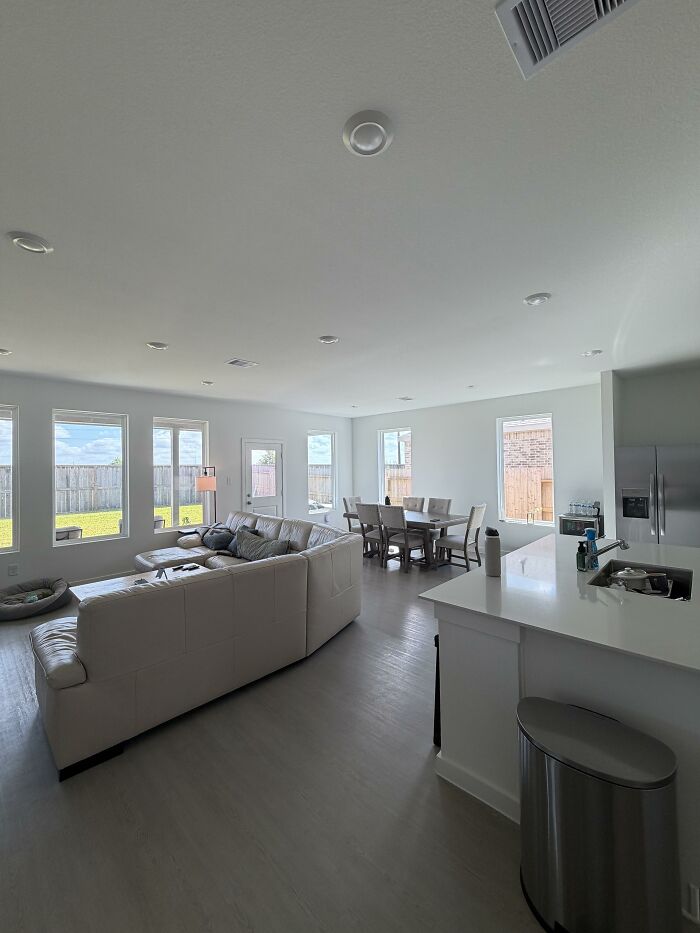 A modern open-concept living and dining area with clean lines, representing home design choices for honest opinions.