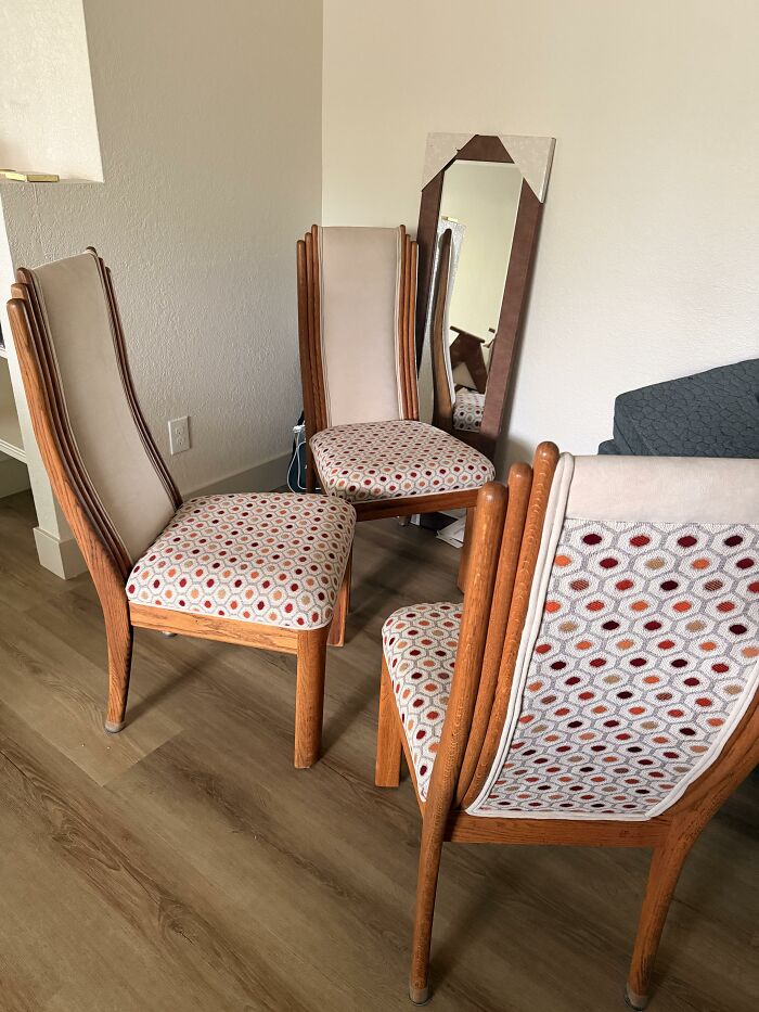 Three unique home design chairs with patterned seats and a floor-length mirror leaning against a wall.