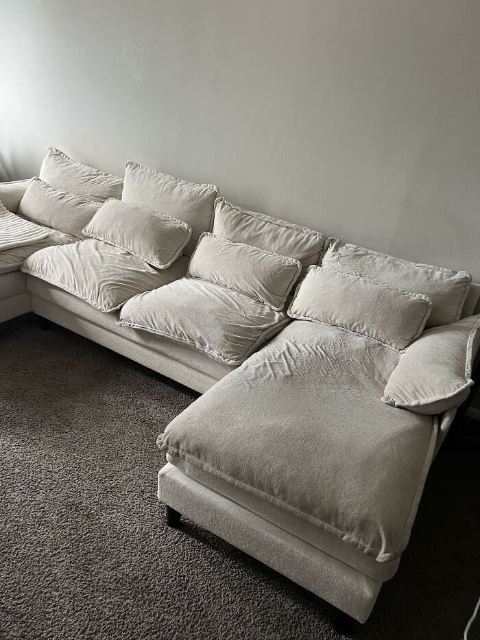 A large, light-colored sectional sofa, showcasing home design choices for comfortable living.