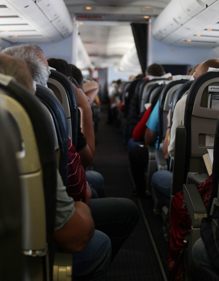 Passengers seated on a flight, experiencing delays or a flight canceled due to an unruly toddler refusing to fasten their seatbelt. Passengers seated on a flight, experiencing delays or a flight canceled due to an unruly toddler refusing to fasten their seatbelt.