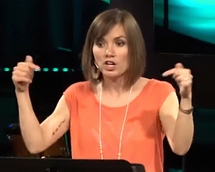 A former pastor and adult industry worker speaks, gesturing with hands, discussing client requests. A former pastor and adult industry worker speaks, gesturing with hands, discussing client requests.